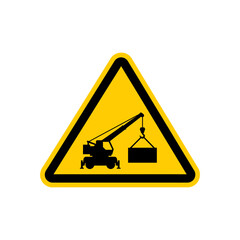 Crane lifts heavy container in construction zone, indicating caution and potential hazards for safety and awareness.