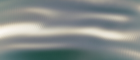 Abstract gray gradient background with a distorted glass effect forming subtle relief. Wavy ribbed surface with soft blur and reflective texture creating a modern artistic look.