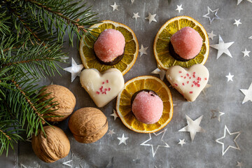 Festive holiday cookies with dried oranges and walnuts top view