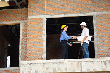 interior design : Caucasian woman Architects and contractor working together inside building under construction site. home renovation process. Engineering in safety harthat helmet. Engineering team