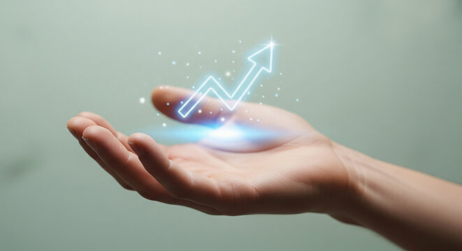 Businessman holding a holographic digital arrow graph in hand, illustrating a concept of business growth, financial success, and technological innovation