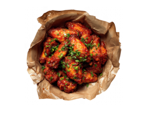 Spicy glazed chicken wings garnished with fresh herbs isolated on a transparent background image