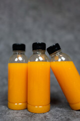 Three bottles  plastic of orange juice