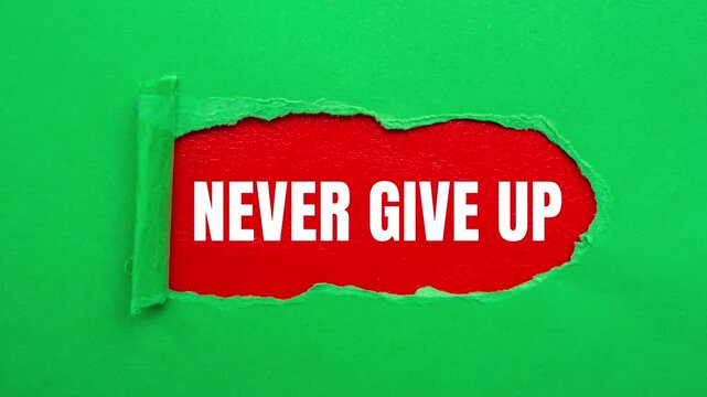 Never Give Up message written on ripped torn paper background