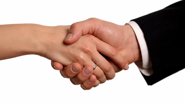 Man and woman in business attire shaking hands, symbolizing a gesture of camaraderie, harmony, collaboration, and a mutually beneficial business agreement