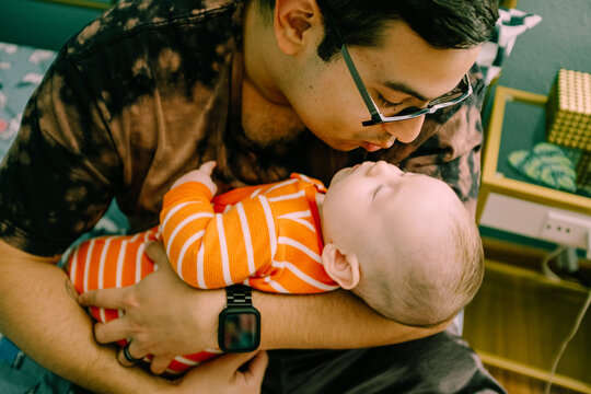 dad kissing baby