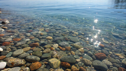 Clear water and pebbles on the shore of lake tahoe on a sunny day