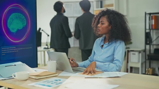 Business professional concentrates in coworking space leveraging AI powered virtual assistant and realtime big data analytics on laptop display for hyper automated workflow intelligence optimization