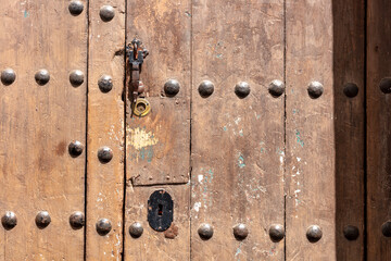 Fototapeta premium Weathered wooden door in Arcos de la Frontera. Andalusia, Spain. 4 September 2025.