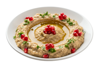 Creamy baba ghanoush spread, garnished with pomegranate seeds and herbs, presented on a white plate against a dark background.