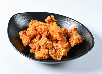 Crispy Honey Glazed Korean Fried Chicken Bites in Black Bowl side view of japanese food