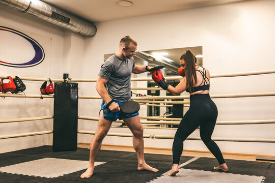 Pair of fighters training in a gym with focus on technique and skill in a boxing ring