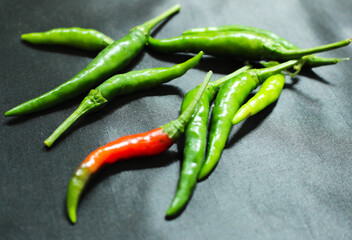 Fresh Green and Red Chili Peppers on Black Background