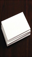Stack of blank white business cards on a dark wooden table