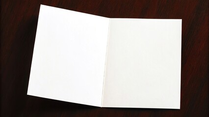 Open blank white folded card on a dark textured surface