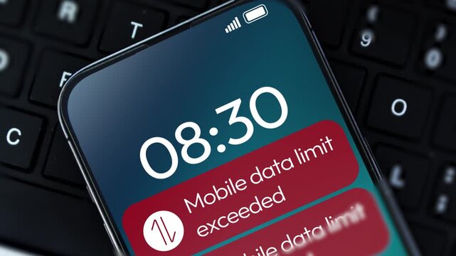 Mobile data limit exceeding notification in red appearing on the smartphone screen close up, 4k footage