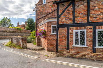 Old historic house decorated with flower basket in Old Amersham in Buckinghamshire, UK