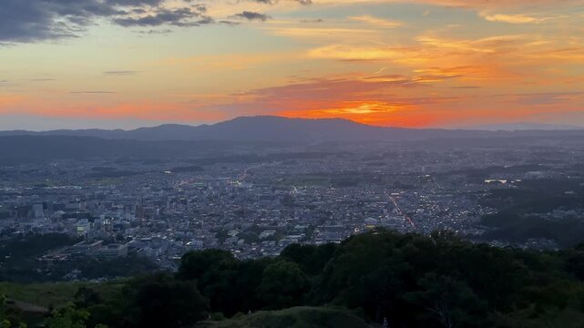 Colorful twilight settling over a distant mountain city