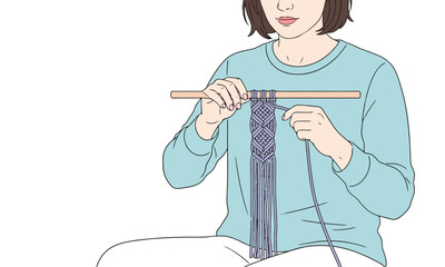 Young woman carefully weaving intricate macrame design, creating beautiful handmade art, perfect for crafting tutorials or creative lifestyle content