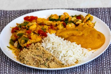 Moqueca capixaba is a typical dish from Espírito Santo, Brazil, made with ocean fish and shrimp. It's cooked gently and flavorfully in a clay pot without the use of palm oil or coconut milk.