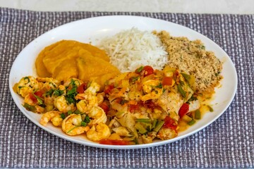 Moqueca capixaba is a typical dish from Espírito Santo, Brazil, made with ocean fish and shrimp. It's cooked gently and flavorfully in a clay pot without the use of palm oil or coconut milk.