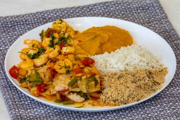 Moqueca capixaba is a typical dish from Espírito Santo, Brazil, made with ocean fish and shrimp. It's cooked gently and flavorfully in a clay pot without the use of palm oil or coconut milk.
