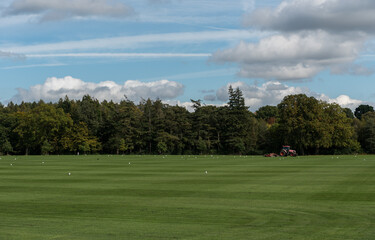 Fototapeta premium LONDON, ENGLAND - SEPTEMBER 28, 2017: Landscape in Windsor Great Park in England with Birds and Tractor on the grass