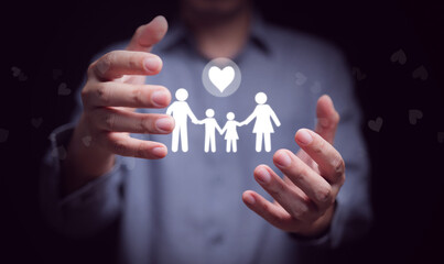 Hands protecting glowing family icon with heart symbol, representing love, care, security, protection, family values, safety, and wellness lifestyle for parents and children.