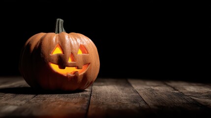 jackolantern with a friendly smile on wooden surface against dark background concept for halloween celebration spooky season decoration and autumnal themed design