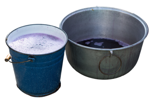 Grape juice close up during the autumn harvest. Traditional old technique of wine making. Filtering grape must.