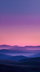 Obraz premium Dreamlike, hazy landscape at dawn or dusk. Soft, layered hills and mountains fade into a vibrant purple and pink sky. A serene, ethereal atmosphere