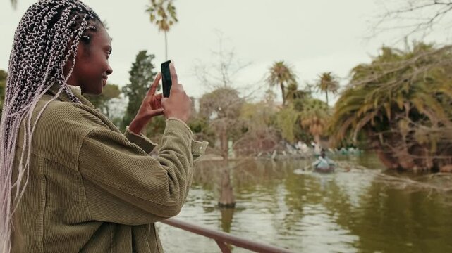 Two women, either best friends or an couple, take photos and enjoy a leisurely day in the park together.