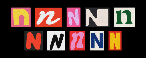 Colorful letter N tiles from magazines, collage against black background
