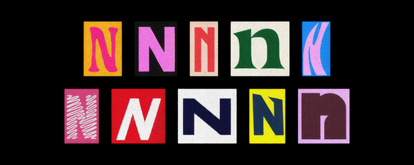 Assorted letter N typography styles, paper cutouts on black background
