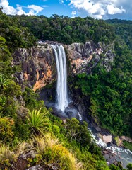 Waterfall cascading into lush forest