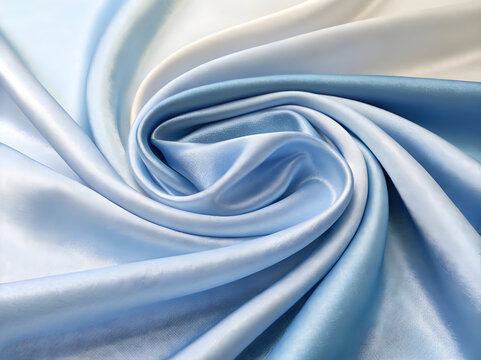 Smooth silk fabric texture featuring a gradient of light blue and white colors arranged in a tight spiral pattern