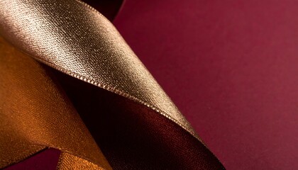 Metallic ribbon draped on deep maroon