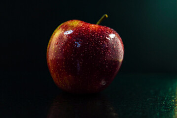red apple on black background