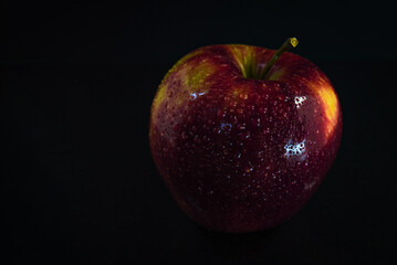 red apple on black background