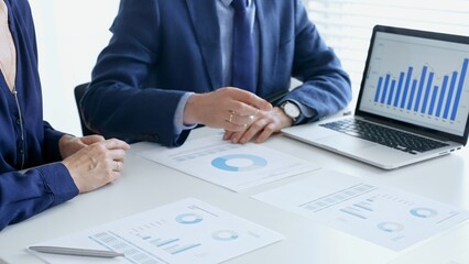 Business people reviewing financial data, discussing and shared documents during collaborative strategy session. Audit and finance concept