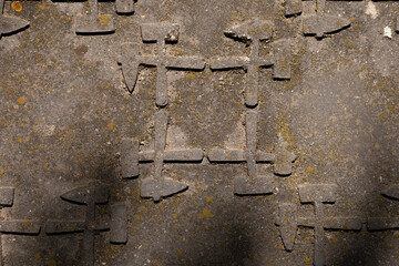Weathered manhole cover with textured arrow pattern
