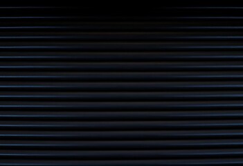 Obraz premium Dark, corrugated metal surface with deep shadows and subtle light reflections, photography, metal texture