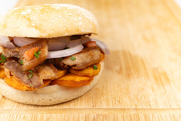 Peruvian Chicharrón Sandwich on a Wooden Board