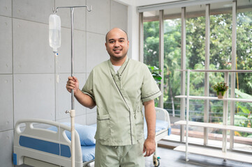 Confident patient stands beside hospital bed, posing in various poses, smiling warmly in gown, showing strength and positivity during recovery in bright and peaceful ward.