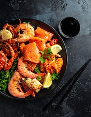 Assorted seafood dish on a dark plate