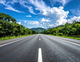 Asphalt Road Through Lush Green Landscape Under Blue Sky