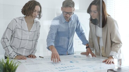 Business team analyzing financial data and discussing growth strategies during a productive meeting in a modern office. Business people concept