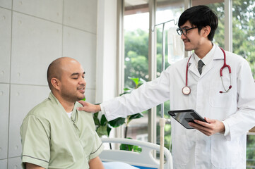 The doctor talks and encourages the patient about treatment options using a digital tablet, promoting clear communication and trust in a bright and supportive hospital environment.