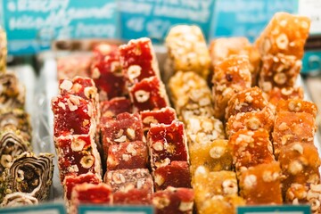 Colorful assortment of traditional sweets displayed in a market, featuring various textures and flavors, showcasing vibrant colors and enticing presentation for culinary enthusiasts