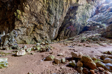 Nimara cave near Marmaris, Turkey inside. Stalactites stalagmites and streak formations in cave of Nimara Magarasi, Turkey. Stone walls and rocks in natural cave. stones covered with moss